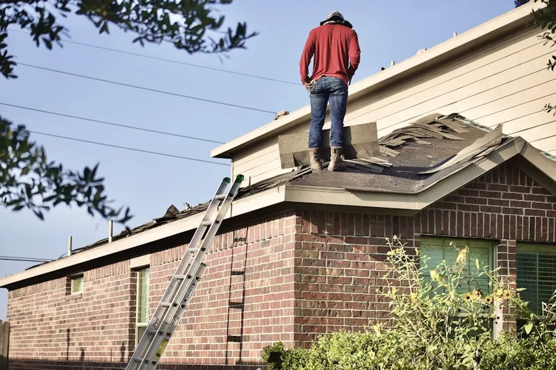 Professional roofer working on a residential roof in Fairhaven